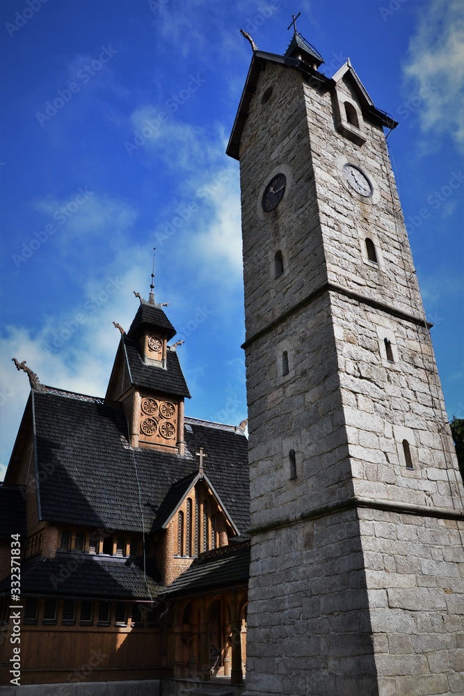 wooden old church and stony tower