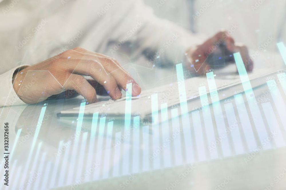 Double exposure of graph with man typing on computer in office on background. Concept of hard work. Closeup. Double exposure of graph with man typing on computer in office on background. Concept of hard work. Closeup.