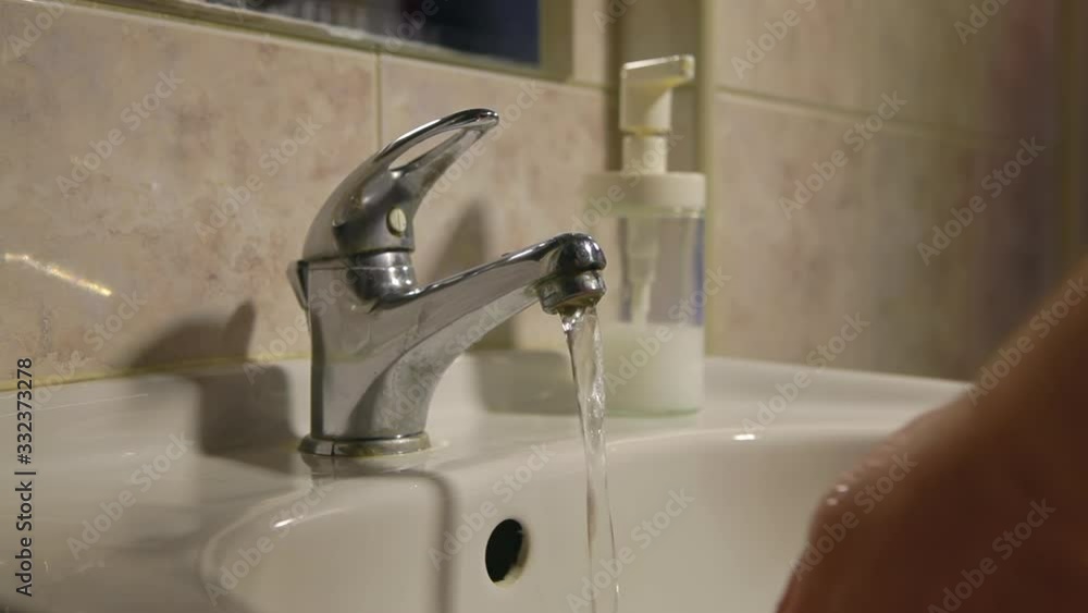 Hand washing against germs and viruses. Close-up of a young man washing his hands thoroughly in the bathroom. Coronavirus pandemic prevention wash hands with soap warm water. Hand washing against germs and viruses. Close-up of a young man washing his hands thoroughly in the bathroom. Coronavirus pandemic prevention wash hands with soap warm water.