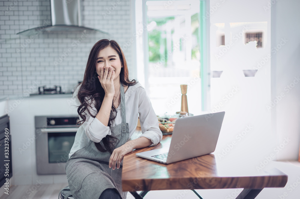 Portrait of beautiful young latin woman talking over the phone while cooking in kitchen Portrait of beautiful young latin woman talking over the phone while cooking in kitchen