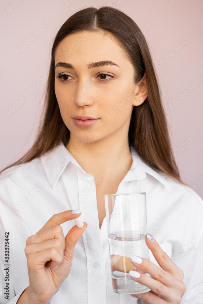 girl drinks pills and water. antibiotic treatment, temperature reduction girl drinks pills and water. antibiotic treatment, temperature reduction