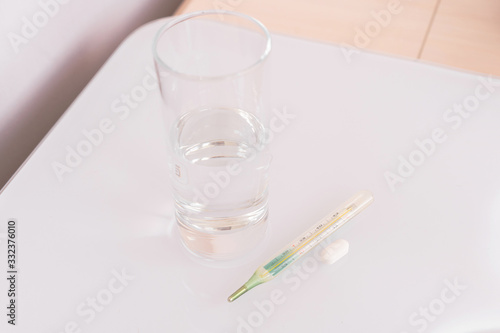  thermometer and pills isolated. treatment of the disease