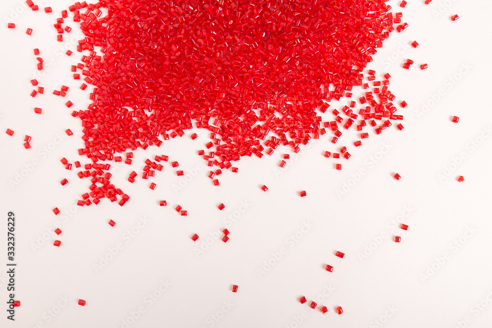 Red, plastic granules of polycarbonate isolated on white background