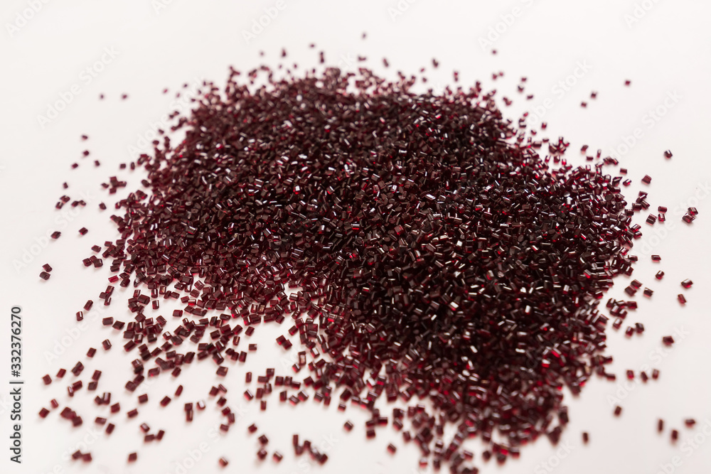 Red, Pomegranate plastic granules of polycarbonate isolated on white background