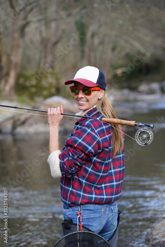 woman fly fishing in river