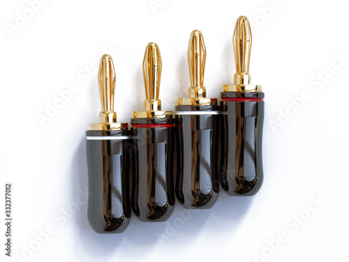 Gold plated red and black high quality banana plugs for cable speakers, isolated on white. photo