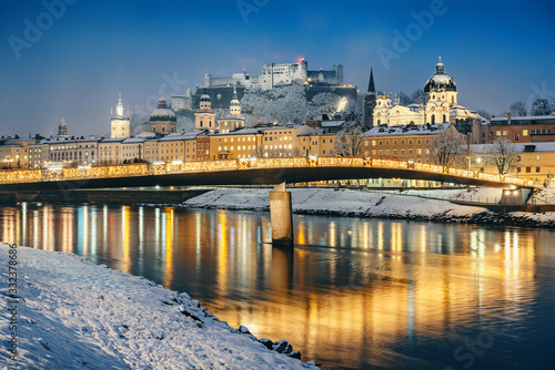 Historic city of Salzburg with Salzach river in winter during at night