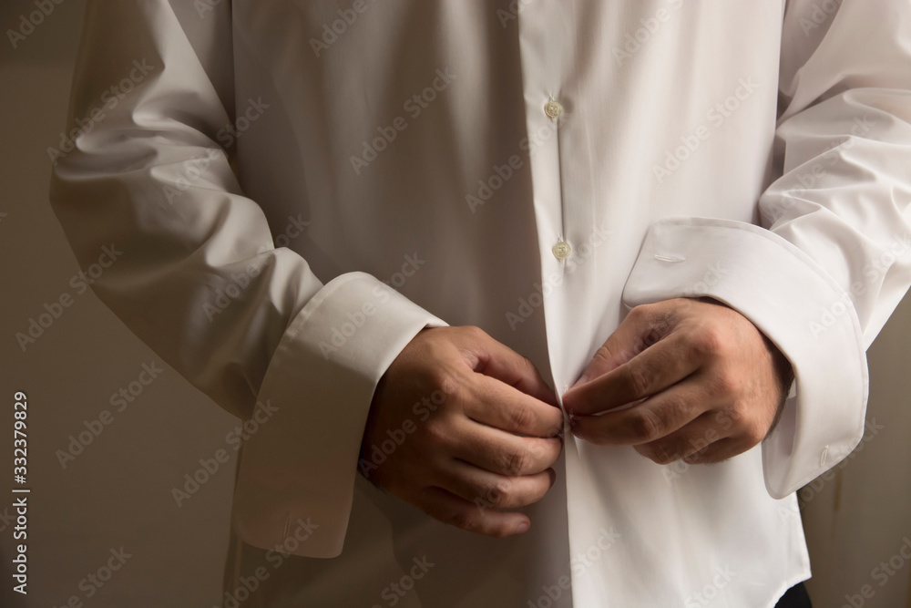 man buttoning shirt buttons man buttoning shirt buttons