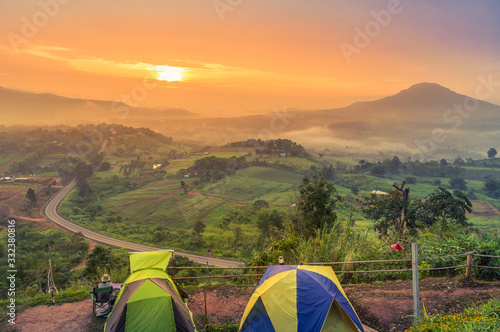 Landscape view camping tents at Khao Takhian Ngo view point in sunrise while misty cover top of mountain Khao Kho, Phetchabun  Thailand. photo