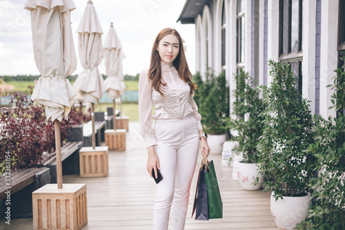 Asia woman holding many shopping bags at shopping mall