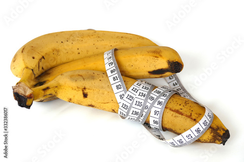 Banana and healthy weight loss, banana and diet, with tape measure on white background,
