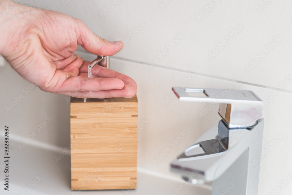 Obraz premium Hand washing with soap in bathroom to prevent contamination, close up