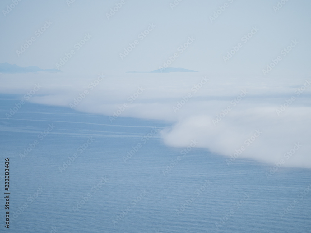 Fototapeta premium Blue background of clouds and sea. View from above. Meteorological phenomena