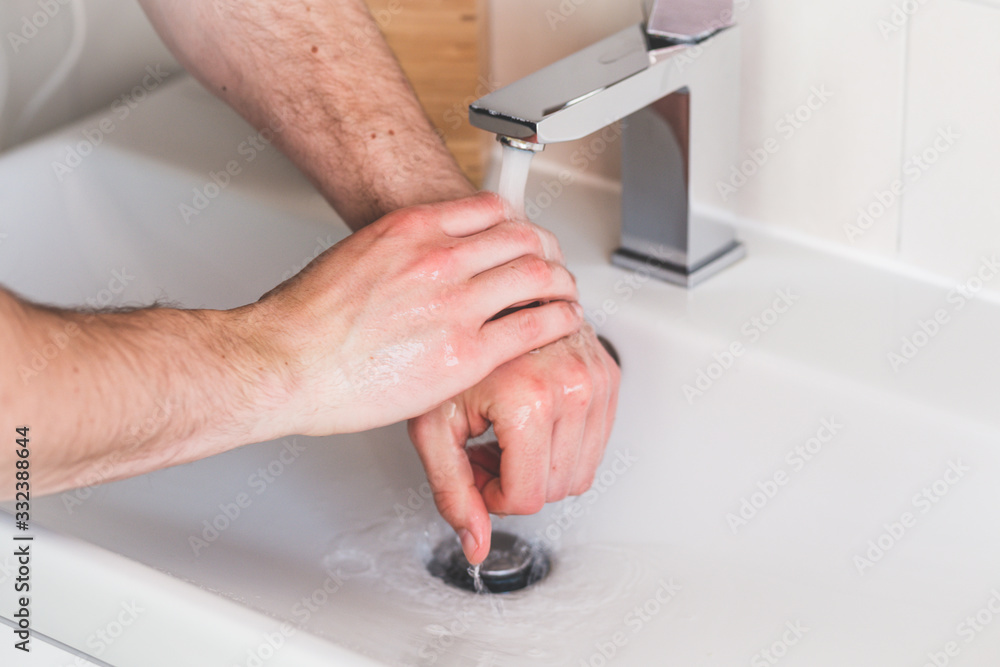 Hand washing with soap in bathroom to prevent contamination, close up Hand washing with soap in bathroom to prevent contamination, close up