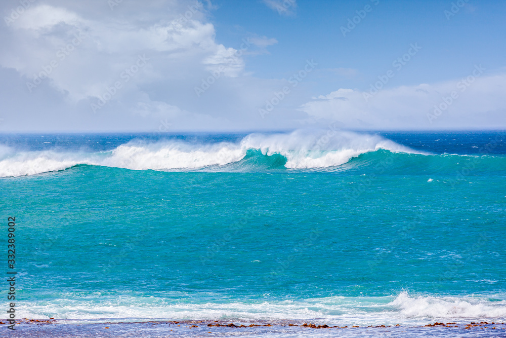 Beautiful turquoise crushing waves near ocean coast