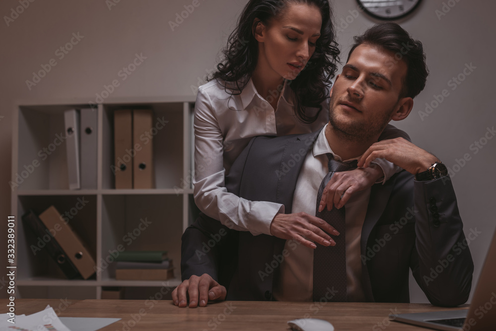 attractive, sensual secretary embracing businessman sitting at desk with  closed eyes Stock-foto | Adobe Stock