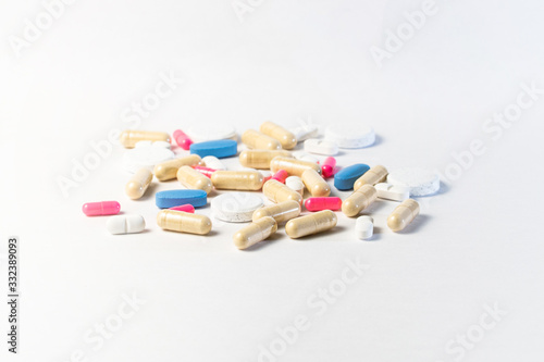 Medicine, virus treatment. Coronavirus vaccine, Covid19. Capsules and pills pink and blue, white background Pandemic medicine.