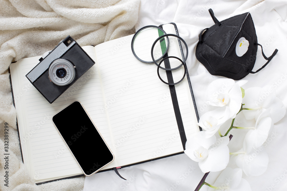 time of isolation, illness. camera, notebook and protective mask. stay at home. photographer's work during quarantine. quarantine and photography.