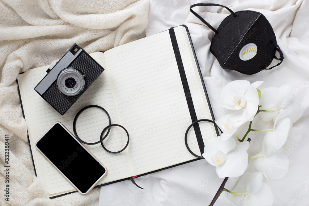 time of isolation, illness. camera, notebook and protective mask. stay at home. photographer's work during quarantine. quarantine and photography.