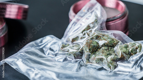 Close-up of medical marijuana buds in vacuum seal bags and grinder.