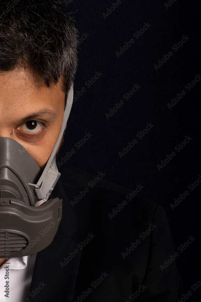 Young handsome with industrial mask to prevent the spread of contagious viruses or chemical gases Young handsome with industrial mask to prevent the spread of contagious viruses or chemical gases