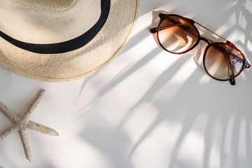 Travel accessories on the table with shadow of plam leave, Summer vacation concept