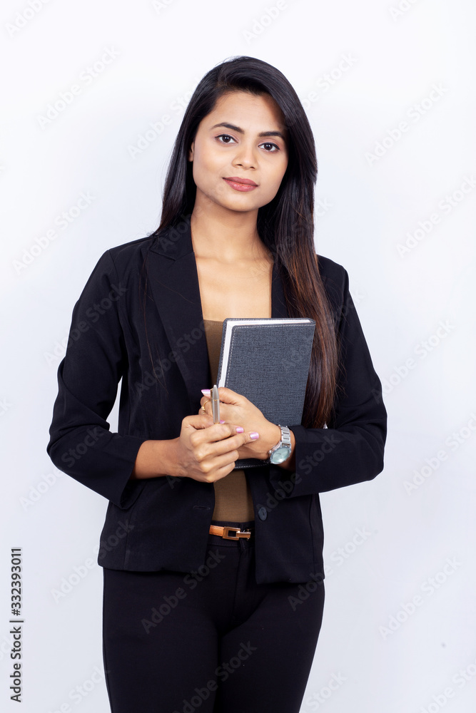Portrait of confident Indian businesswoman holding diary on white background Portrait of confident Indian businesswoman holding diary on white background