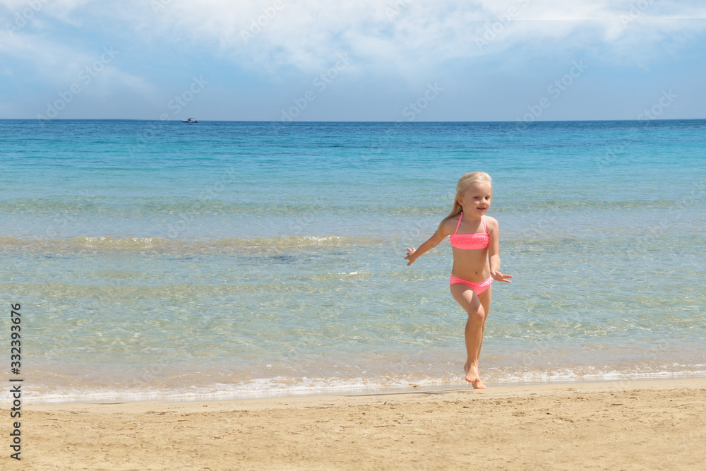 Little girl at the beach. Summer vacation concept