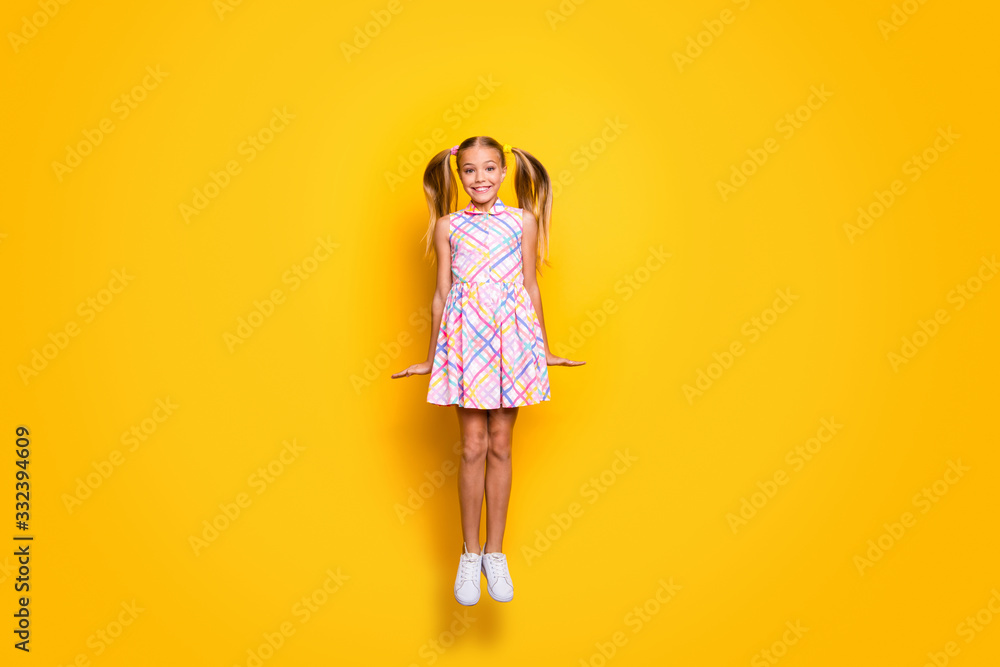 Full body photo of content dreamy schoolkid jump enjoy rest relax spring weekend holiday wear trendy checkered skirt isolated over shine color background Full body photo of content dreamy schoolkid jump enjoy rest relax spring weekend holiday wear trendy checkered skirt isolated over shine color background