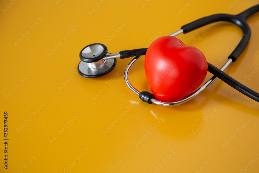 Stethoscope doctors and red heart cardiology placed on a white table in the hospital, concept: diagnostics disease health prescription for a patient, valentine day symbol Love and care healthcare Stethoscope doctors and red heart cardiology placed on a white table in the hospital, concept: diagnostics disease health prescription for a patient, valentine day symbol Love and care healthcare
