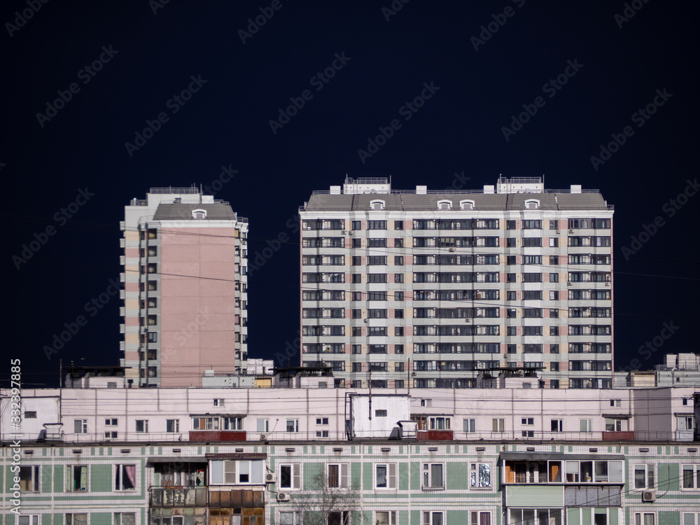 Clear dark sky over apartment buildings of the urban district. Panorama of the cityscape before storm. Moscow city, Russia. Clear dark sky over apartment buildings of the urban district. Panorama of the cityscape before storm. Moscow city, Russia.