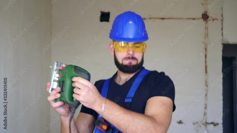 Happy cheerful male builder dancing at work. The working man is dancing. Happy cheerful male builder dancing at work. The working man is dancing.