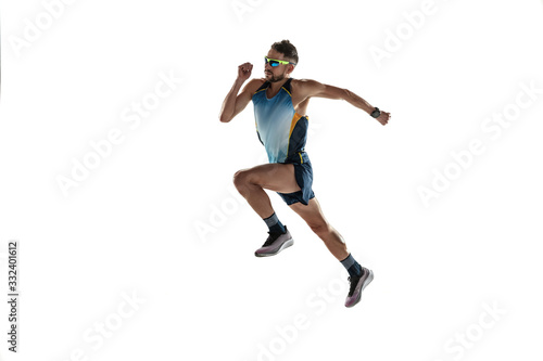 Triathlon male athlete running isolated on white studio background. Caucasian fit jogger, triathlete training wearing sports equipment. Concept of healthy lifestyle, sport, action, motion. In jump. © master1305
