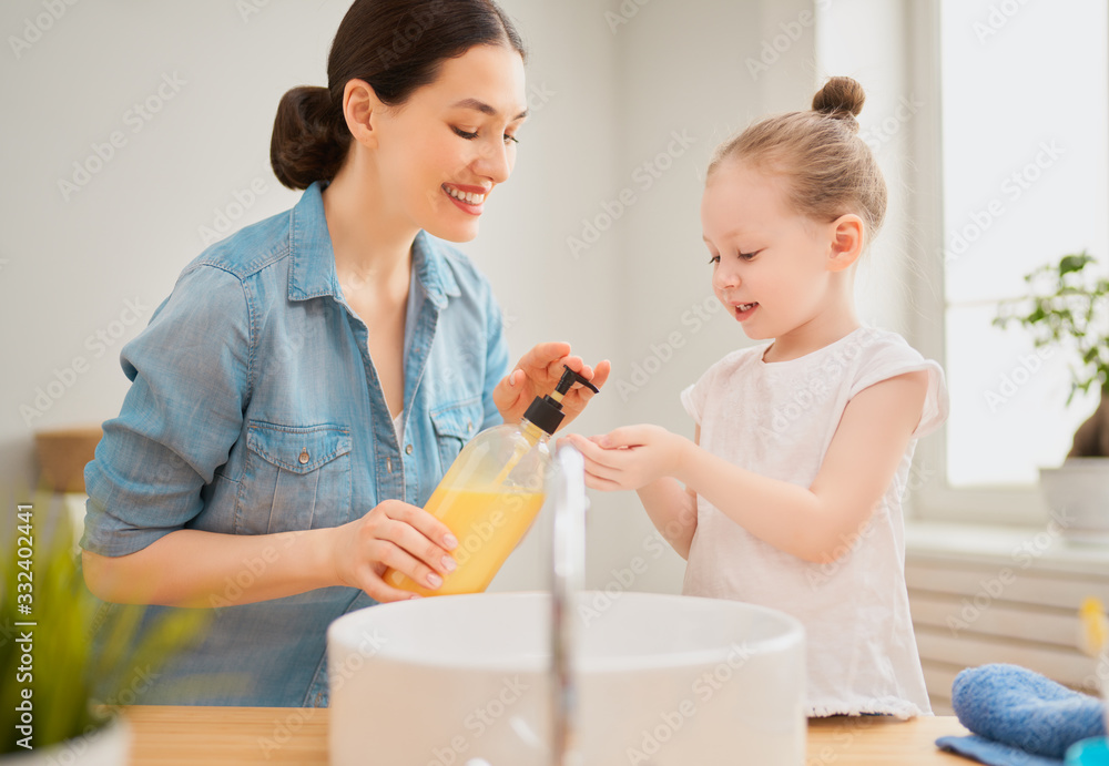 girl and her mother are washing hands girl and her mother are washing hands