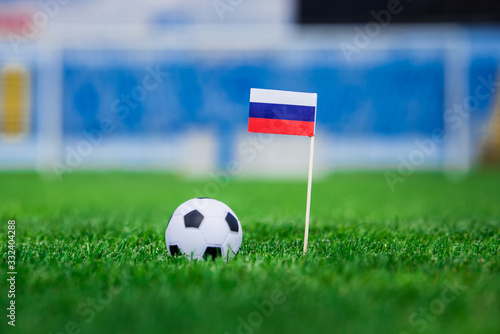 Russia Flag and football ball on green grass. Photo  copy space.