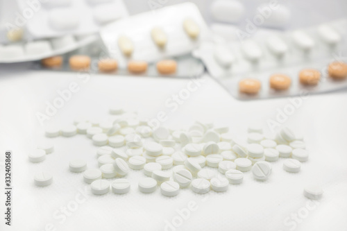 The concept of pills for treatment. Multi-colored pills on a white background isolate. Copy space. Place for text.