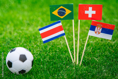 National Flags of Brazil  Switzerland  Costa Rica  Serbia. Flags on green grass on football stadium