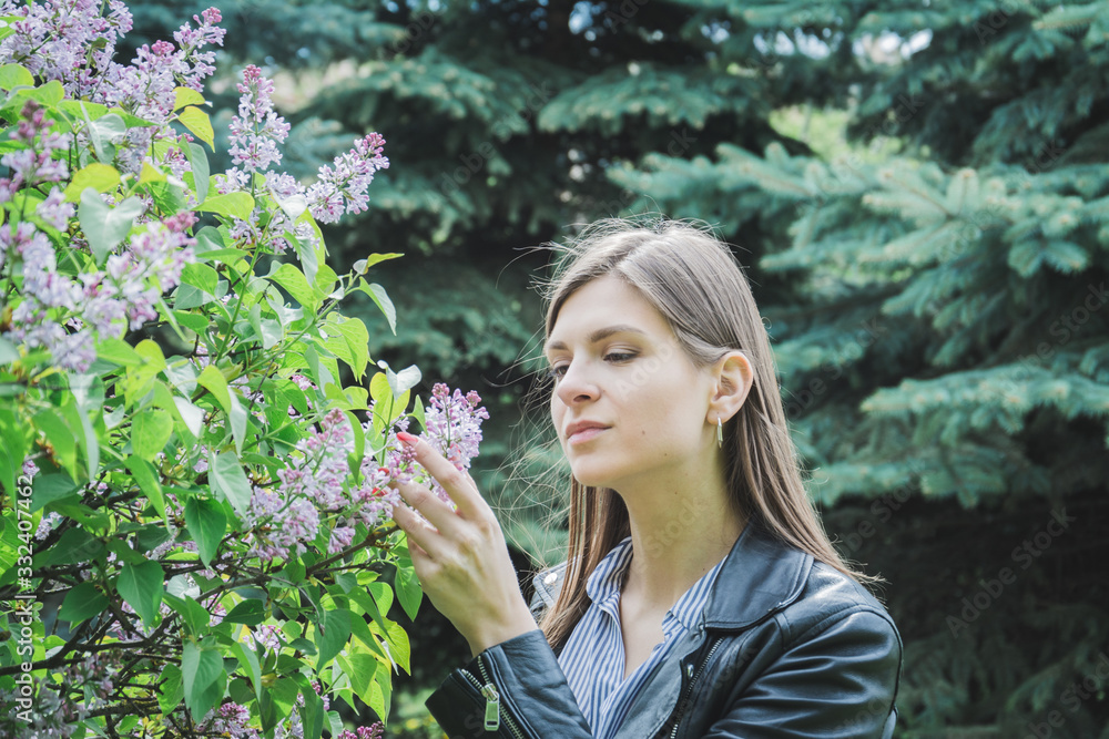 Portrait of funny smiling girl on blooming lilac bush Portrait of funny smiling girl on blooming lilac bush