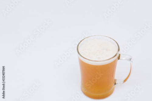 Man holding beer mug full of beer on wooden table on white background