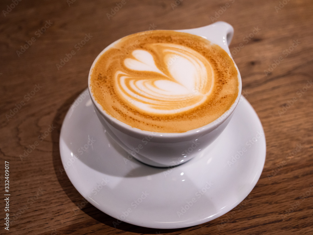 A coffee with a beautiful latte art heart on top A coffee with a beautiful latte art heart on top