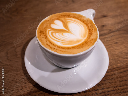 Fototapeta A coffee with a beautiful latte art heart on top