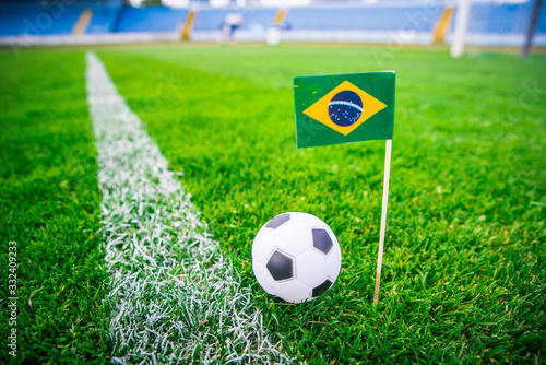 Brazil national Flag and football ball on green grass. Fans  support photo  edit space