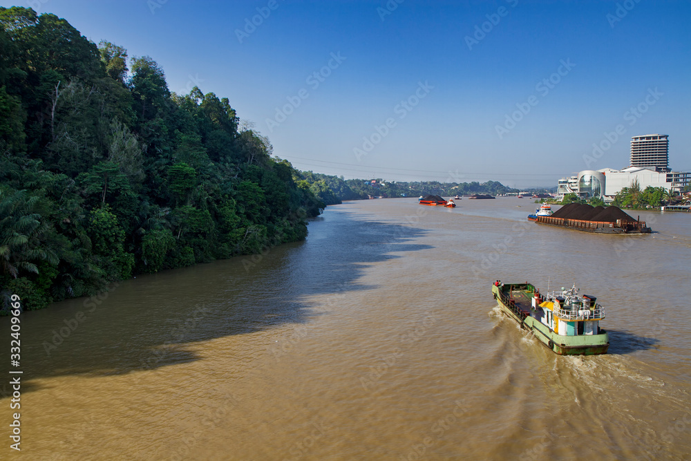 coal transported by the barges on Mahakam river, Samarinda, East Kalimantan, Indonesia coal transported by the barges on Mahakam river, Samarinda, East Kalimantan, Indonesia
