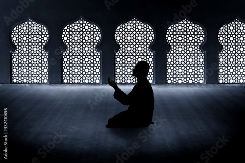 Fototapeta Silhouette of muslim man praying