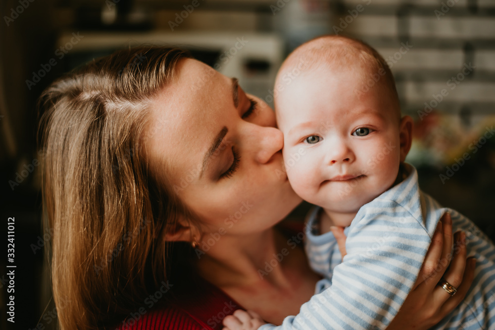A mother holds a baby in her arms. A mom kisses a infant. A women hugs her toddler. A girl has fun and rejoices with the child. A mother holds a baby in her arms. A mom kisses a infant. A women hugs her toddler. A girl has fun and rejoices with the child.