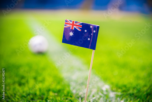 Australia national Flag and football ball on green grass. Fans, support photo, edit space