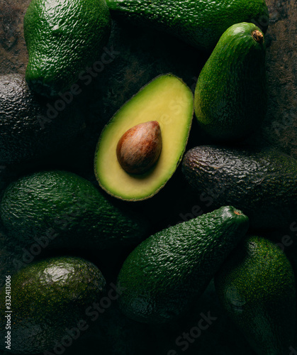 open avocado on group of avocados  photo