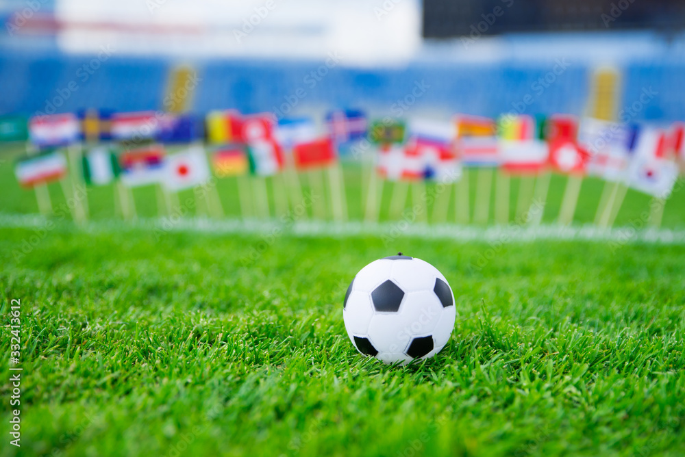 All nations flag on football green grass. Football net and blue sky in background All nations flag on football green grass. Football net and blue sky in background