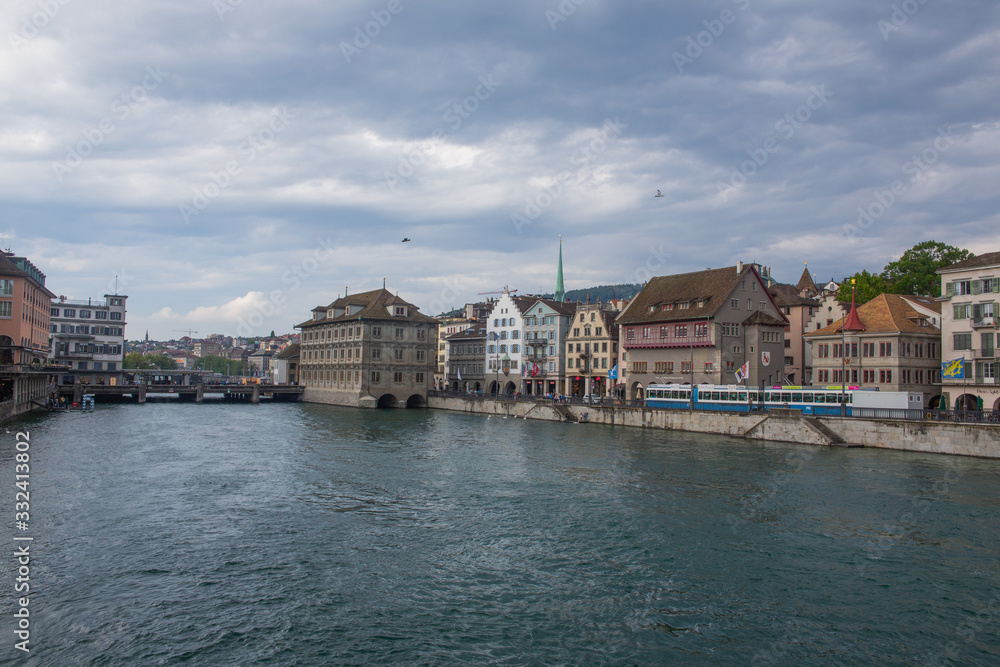 Street in Zurich and quiet Limmat river waters