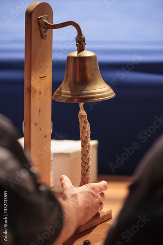 hand holding a boxing bell